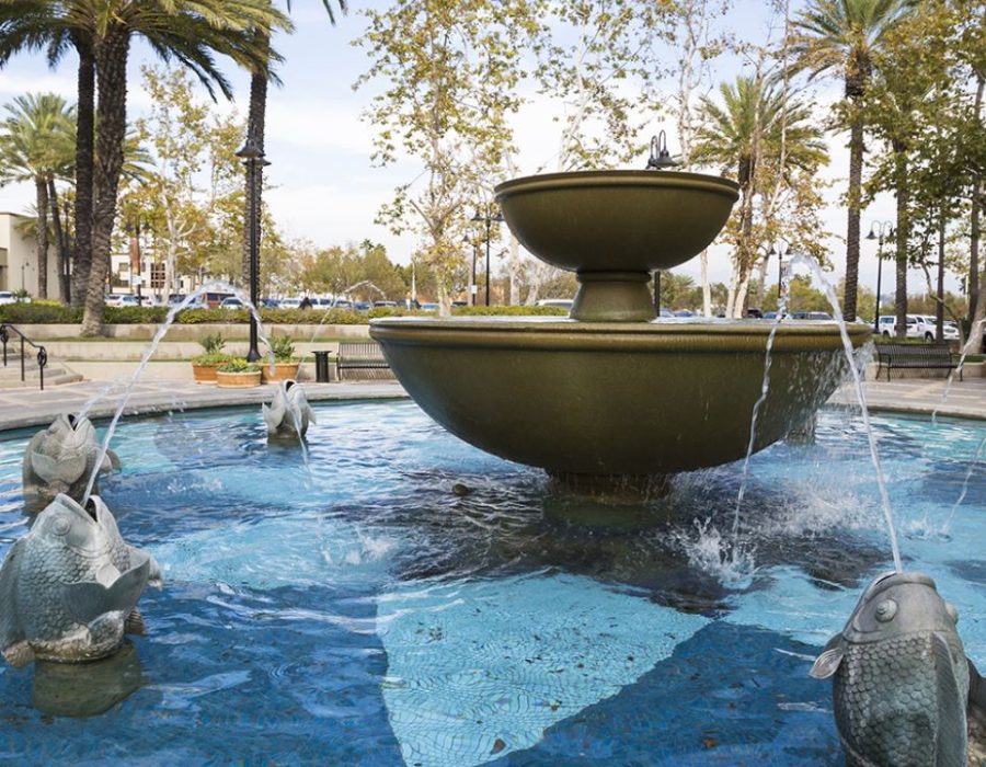 Fountain surrounded by palm trees.